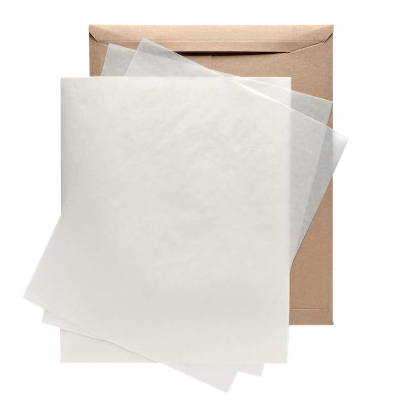 Glassine sheets layered on top of a brown envelope.