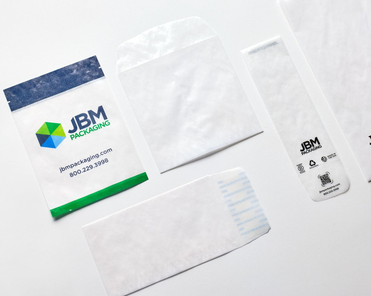 JBM Packaging products including bags and labels on a white background. 