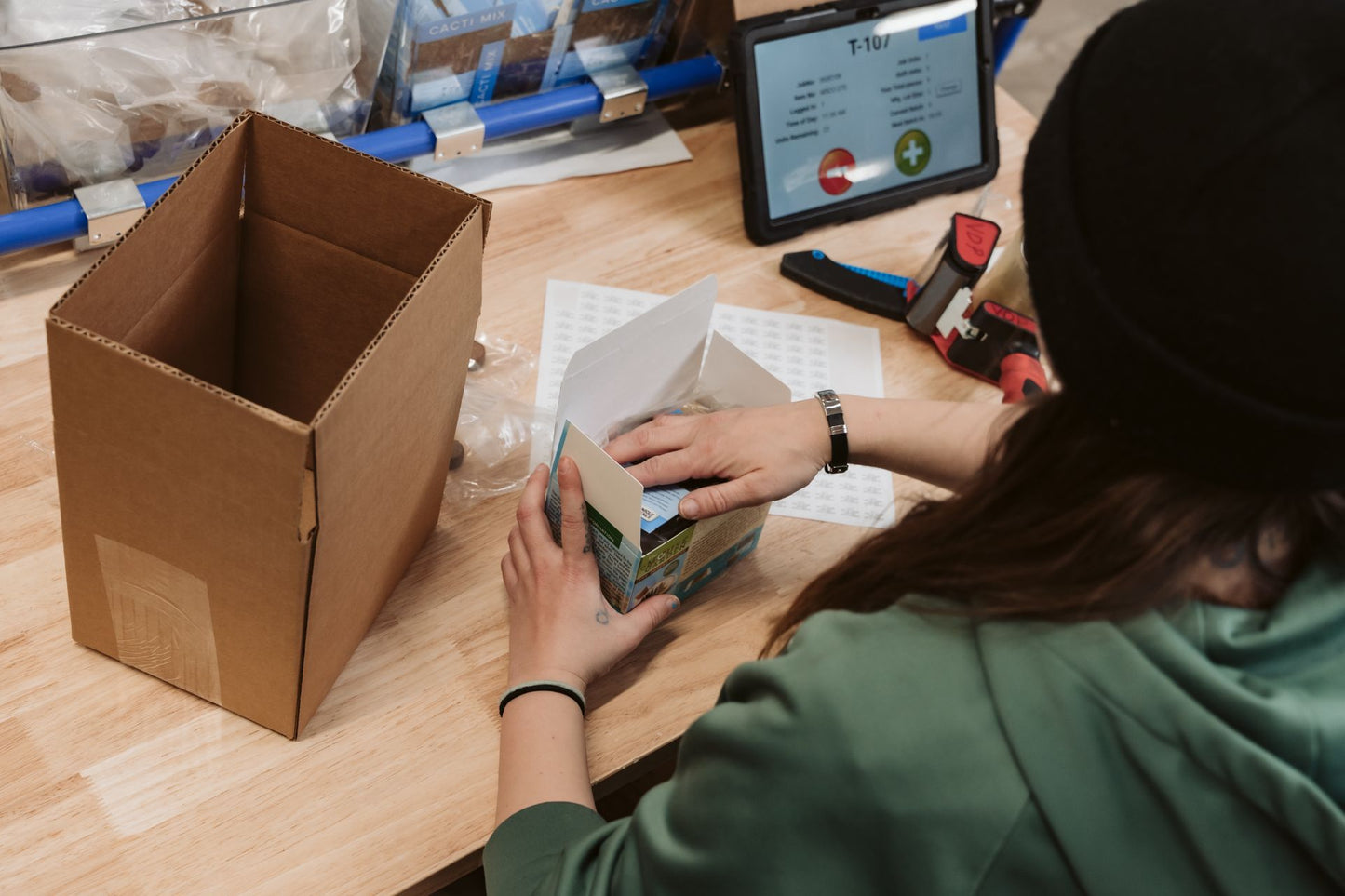 JBM employee packaging seed envelopes. 
