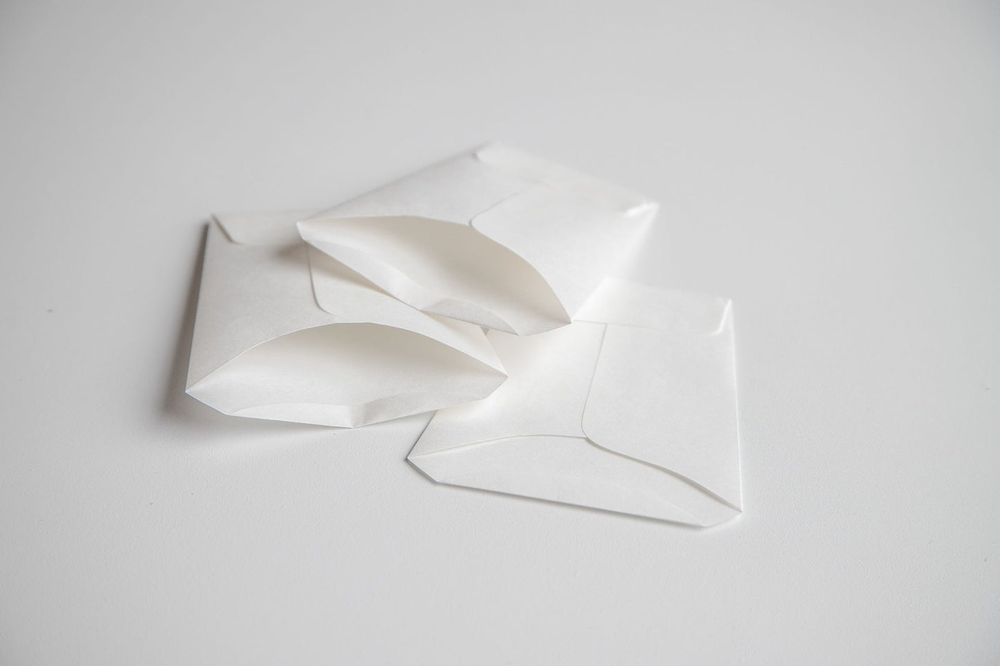 Three white quick cups laying on top of one another. 