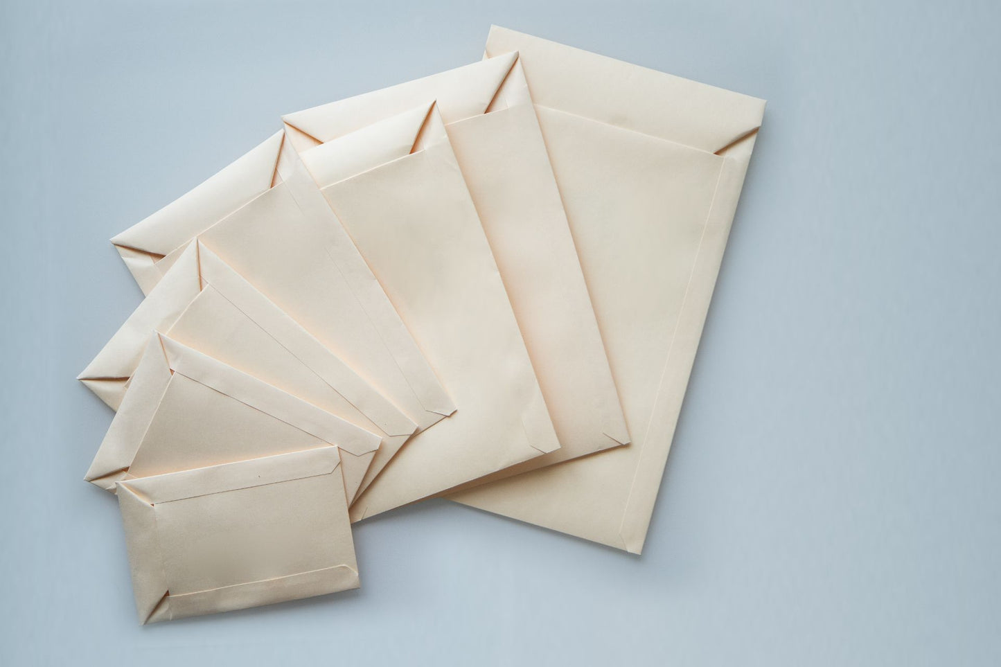 Different sizes of spear envelopes overlapping eachother. 